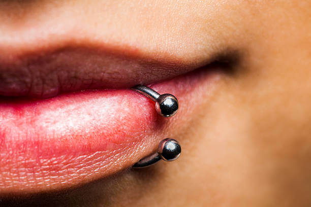 Extreme close up of young woman's mouth with piercing