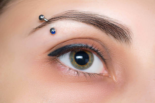 Eyebrow piercing. Eyelash tattoo. Cosmetic procedures